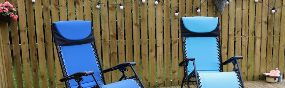 two blue padded relaxer chairs on patio space with string lights and flowers in the background