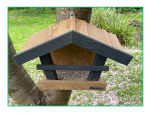 wooden bird feeder on tree