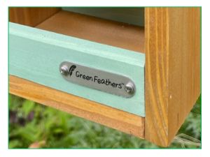 wooden hanging bird feeder with bird food suet tube