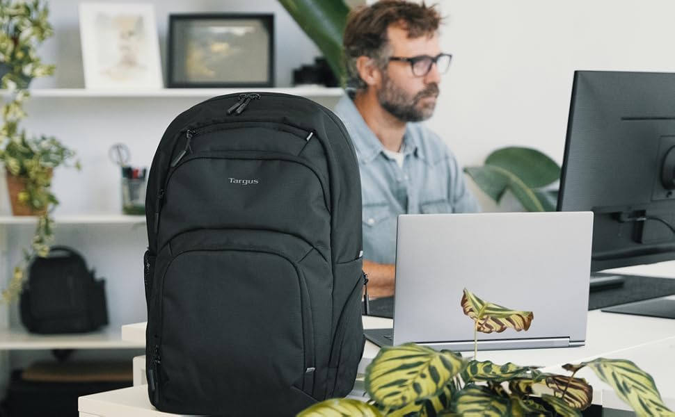 black targus laptop backpack in office on desk next to plant