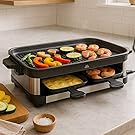 Raclette grill on kitchen counter with meats, veggies, and cheese melting in trays