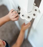 baby tries to open cabinets with lock