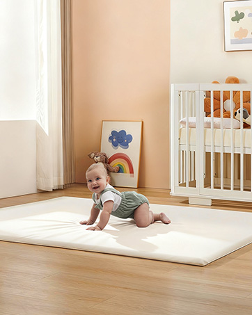 a baby laying on Attababy 39" round play mat