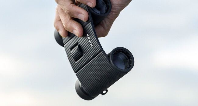 TRAILBLAZER II binoculars sitting on a rock