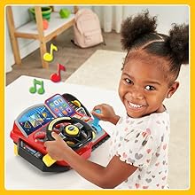 Kid pretends to drive. Toy says, We need five gallons of gas!