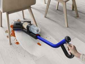 The Dyson WashG1 cleaning low underneath a dining room chair