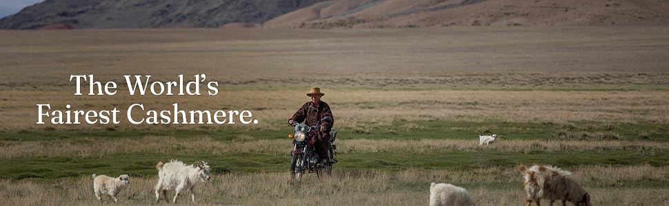 Farmer on motorbike in grassy landscape