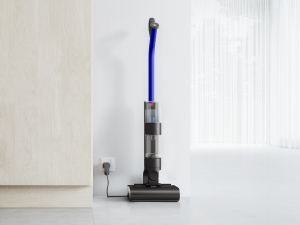 The Dyson WashG1 being charged against a wall
