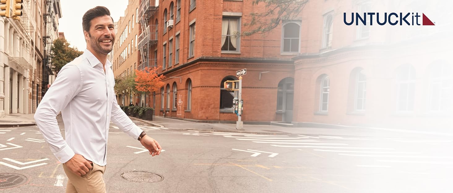 Man wearing a white untucked shirt walks across the street with UNTUCKit logo displayed.