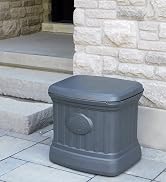 Black storage bin, outdoors, sitting in front of a stone wall