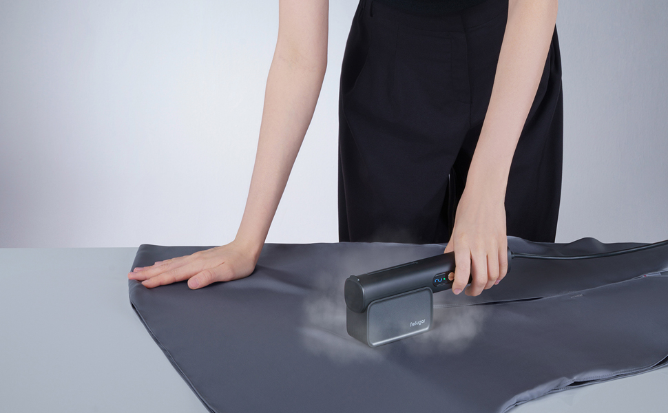 a woman using a hair dryer to blow out a dress.