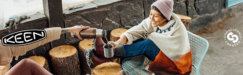 Three women in beige pants and monochrome KEEN sandals lean against a wall. KEEN logo.