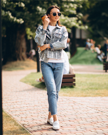 A youth beautiful women wearing a pair of brown women's penny loafers.