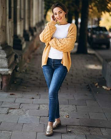 A 25 years old women wearing black patent loafers walks along street.