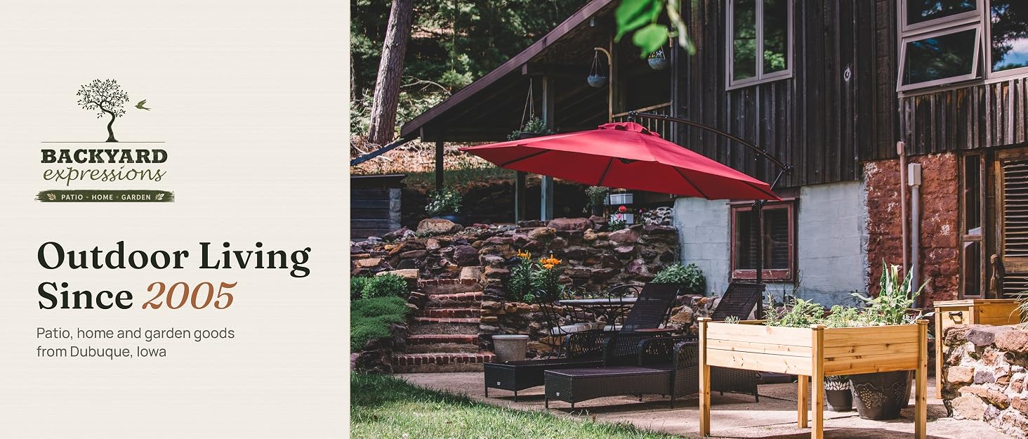 Backyard Expressions patio with a red offset umbrella, lounge chairs and an elevated cedar planter